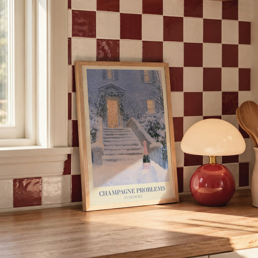Champagne Problems Winter Taylor Swift print of champagne on snowy steps, on a kitchen counter against red and white checked tiles
