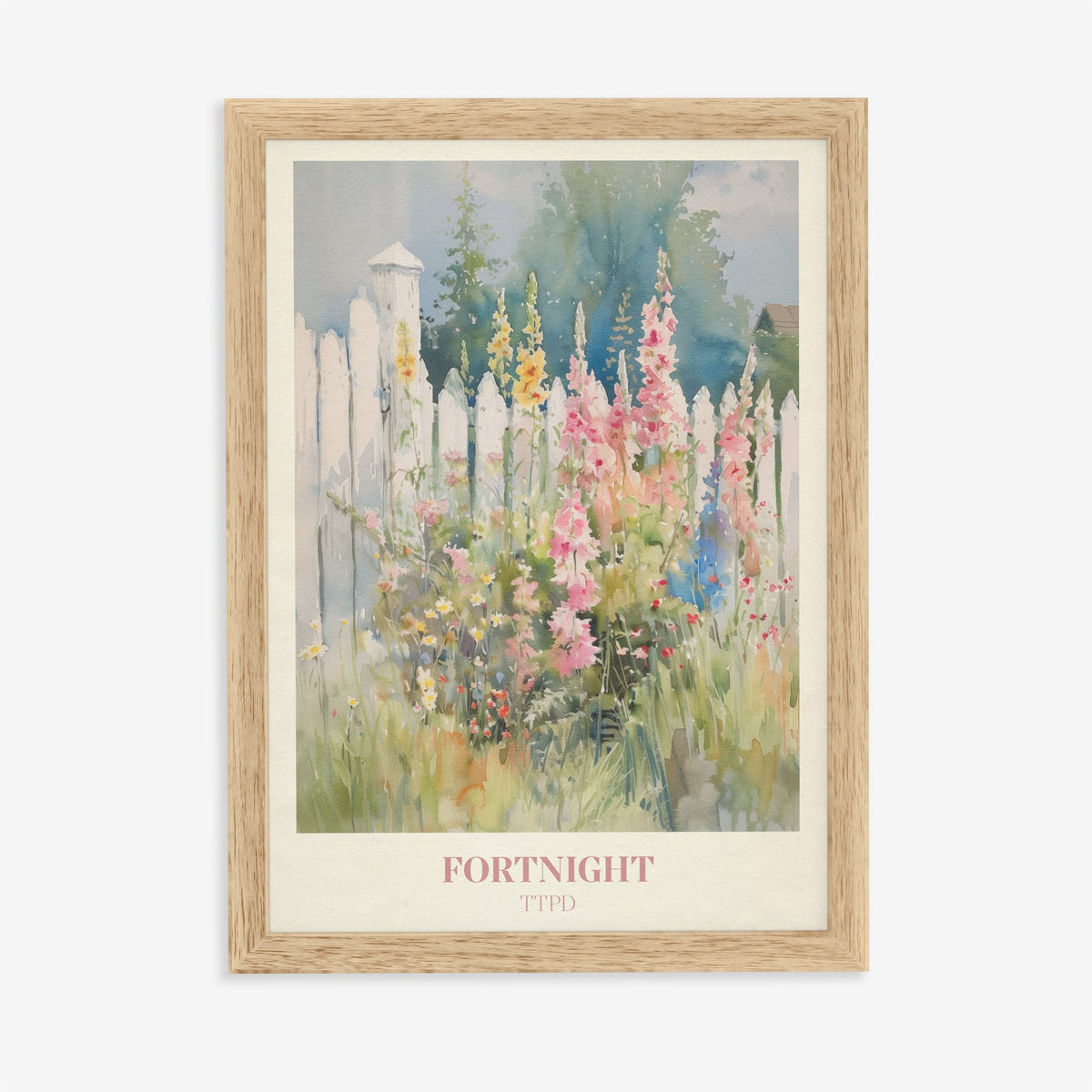 Fortnight Taylor Swift print of hollyhocks and wildflowers by a white picket fence, in an oak frame on a plain wall