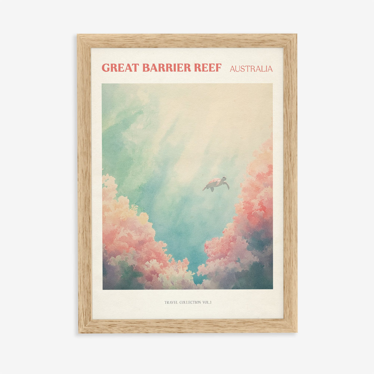 Great Barrier Reef travel print of a sea turtle swimming above pink coral in turquoise water, in an oak frame on a plain wall