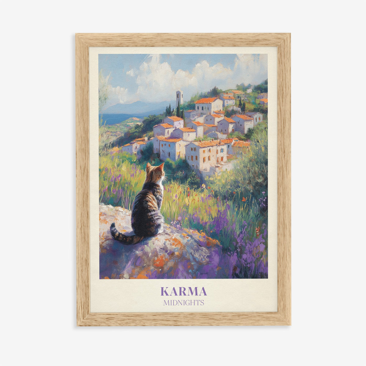 Karma Taylor Swift print of a tabby cat looking out over a hilltop village and lavender, in an oak frame on a plain wall