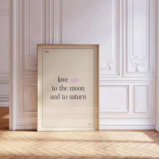 Love You To The Moon Taylor Swift print of the lyric in black and pink type on cream, framed, leaning against a white panelled wall
