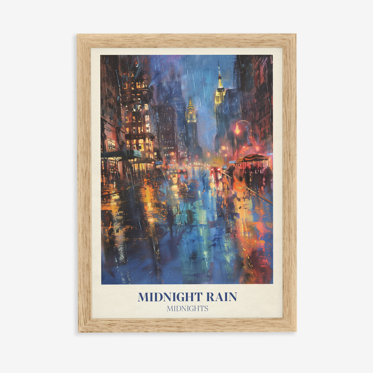 Midnight Rain Taylor Swift print of a rain-soaked city street glowing under skyscrapers at night, in an oak frame on a plain wall