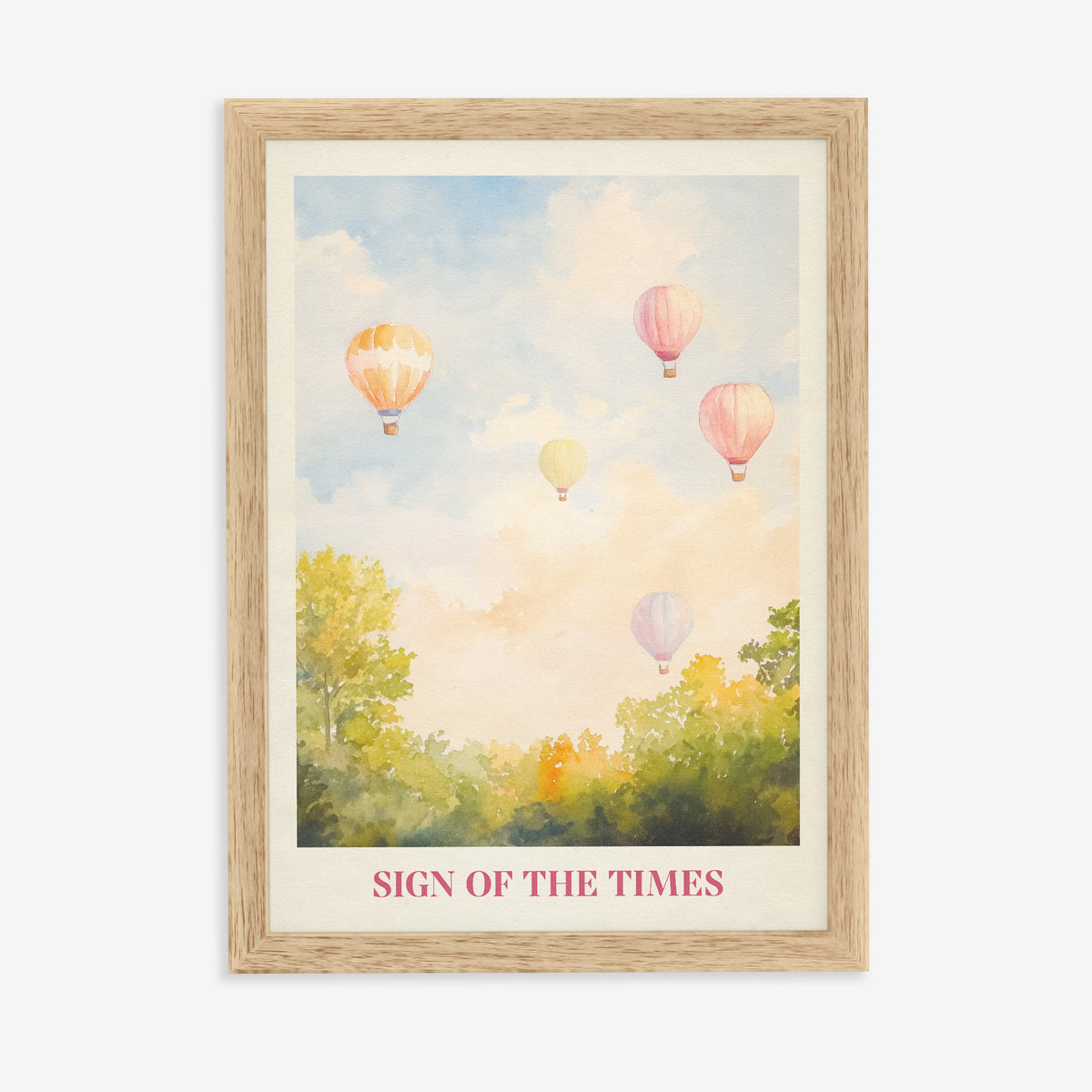 Sign Of The Times Harry Styles print of hot air balloons over trees in a pastel sky, in an oak frame on a plain wall