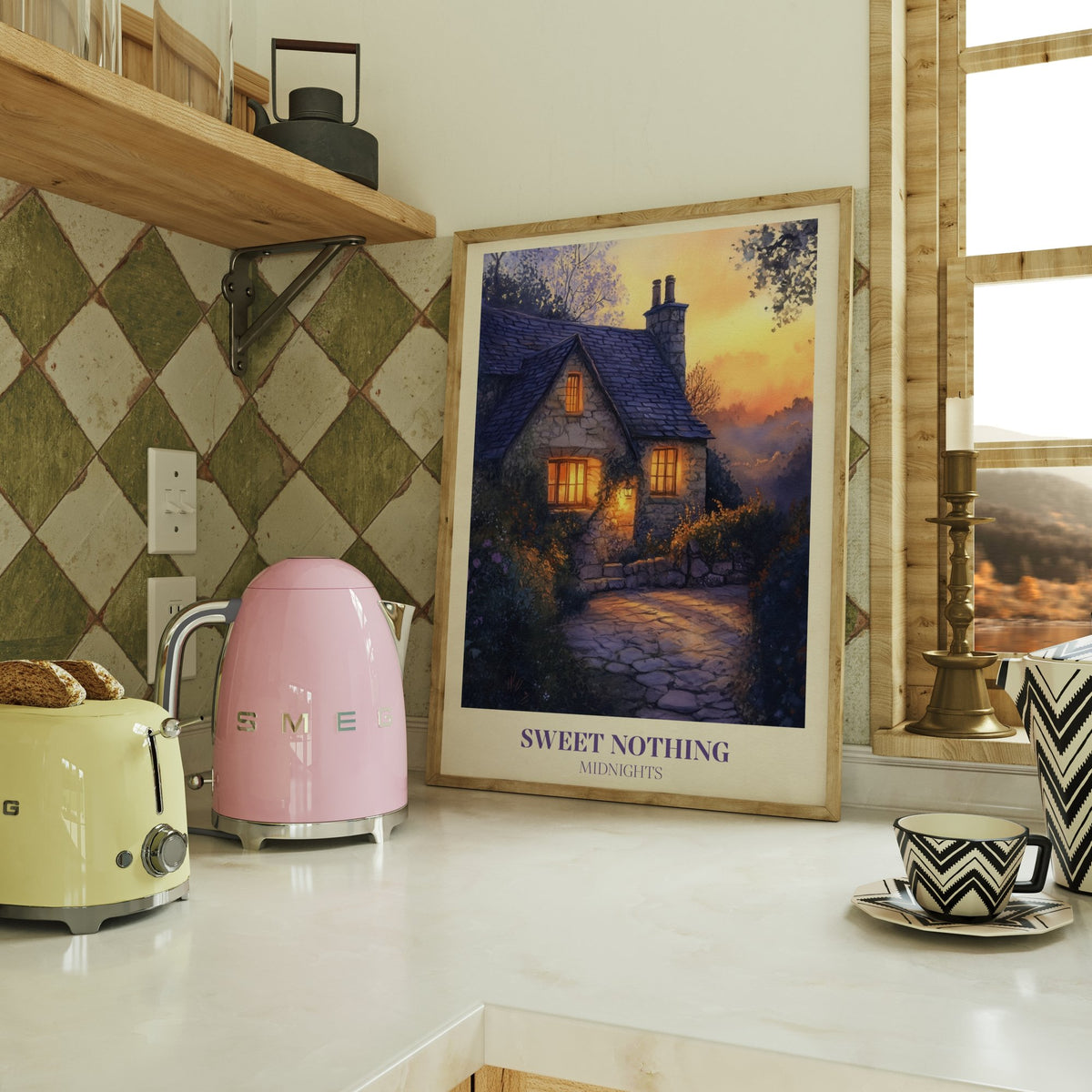 Sweet Nothing Evening Cottage Taylor Swift print of a stone cottage with glowing windows at dusk, framed on a kitchen counter
