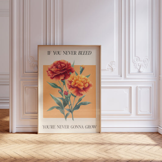 The 1 Botanical Taylor Swift print of red and orange carnations on a peach square, framed, leaning against a white panelled wall