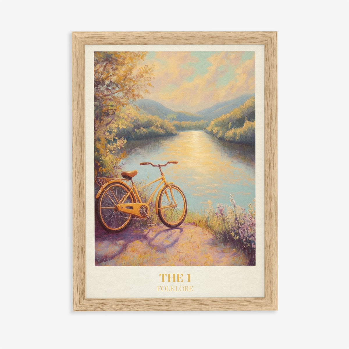 The 1 Taylor Swift print of a yellow bicycle beside a sunlit river, in an oak frame on a plain wall