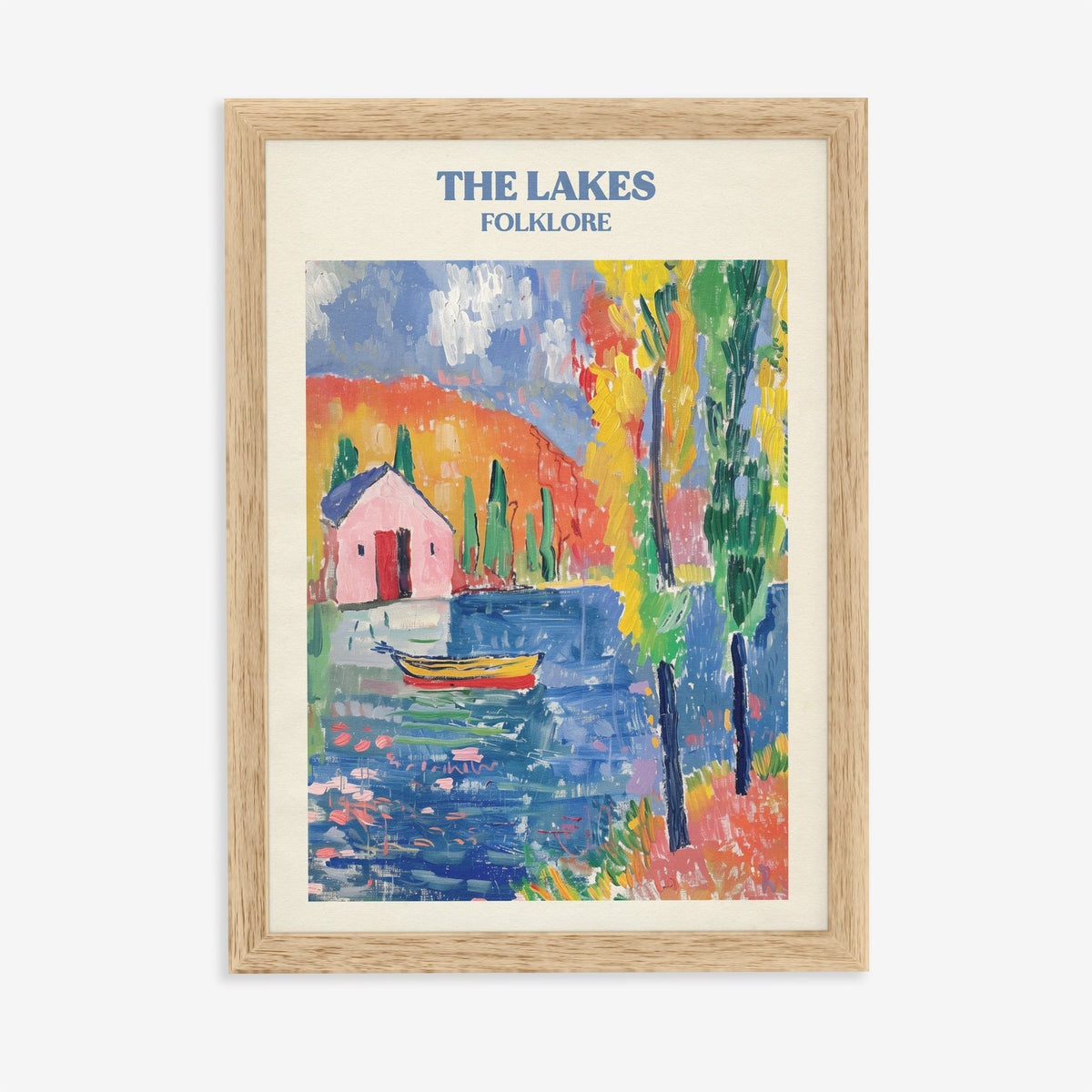 The Lakes Matisse Taylor Swift print of a pink cottage and a boat on a bright blue lake, in an oak frame on a plain wall