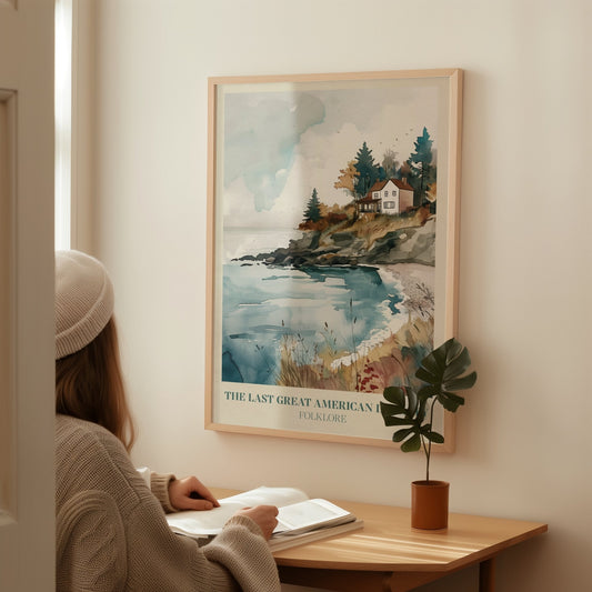 The Last Great American Dynasty Taylor Swift print of a white clifftop house above a cove, framed above a desk where someone is reading
