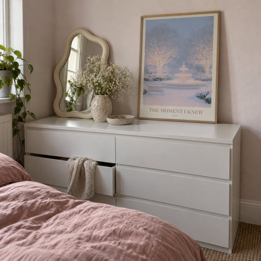 The Moment I Knew Taylor Swift print of a fairy-lit snowy park, leaning on a white dresser beside a wavy mirror