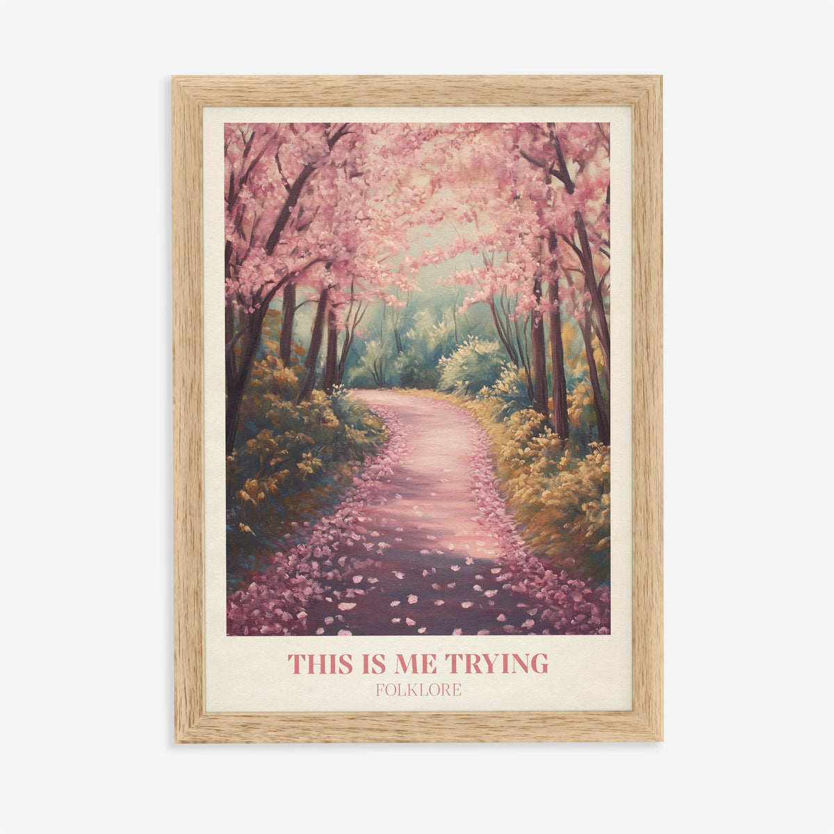 This Is Me Trying Taylor Swift print of a winding path under pink blossom trees, in an oak frame on a plain wall