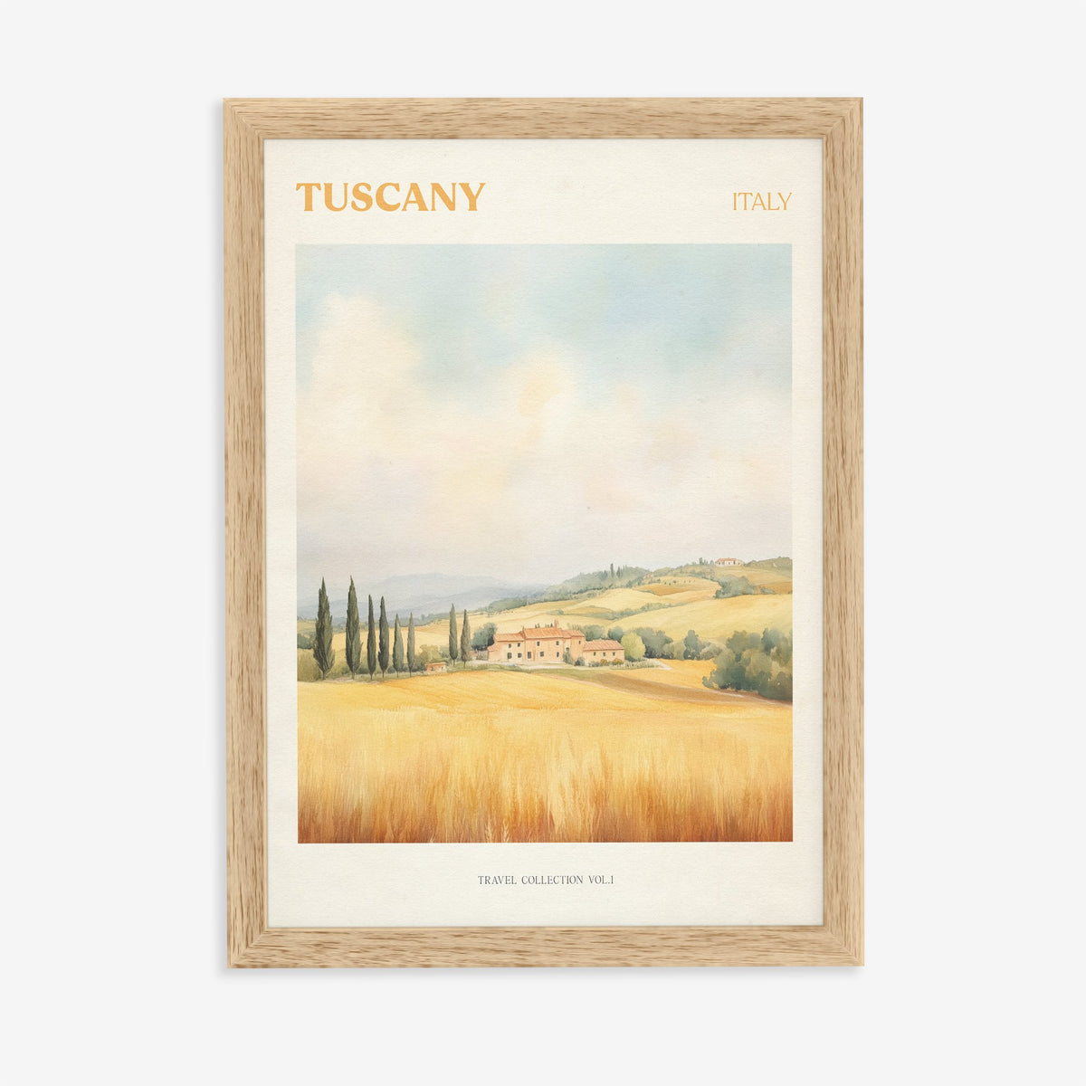 Tuscany travel print of a hilltop farmhouse above golden wheat fields and cypress trees, in an oak frame on a plain wall
