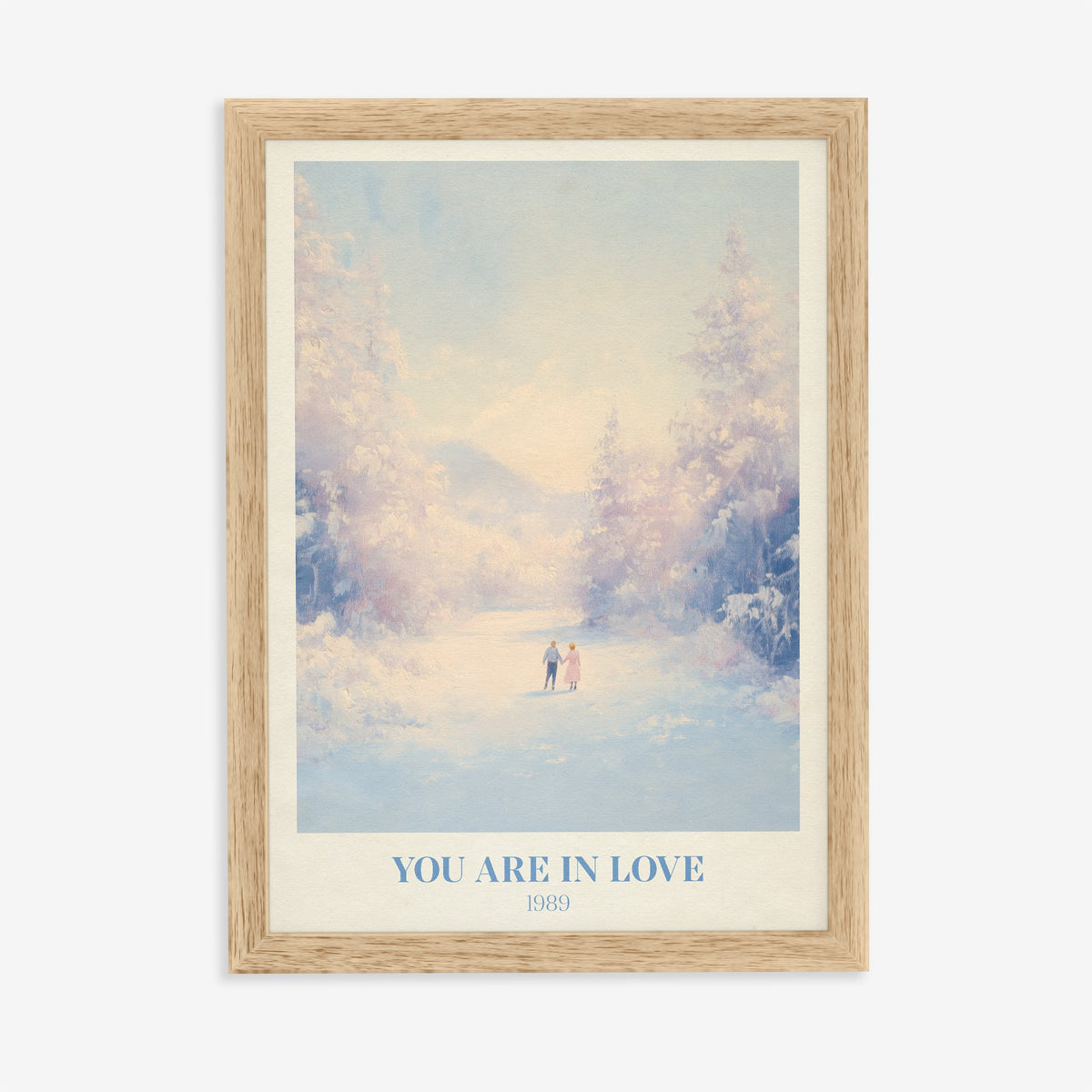 You Are In Love Taylor Swift print of a couple holding hands on a snowy path, in an oak frame on a plain wall