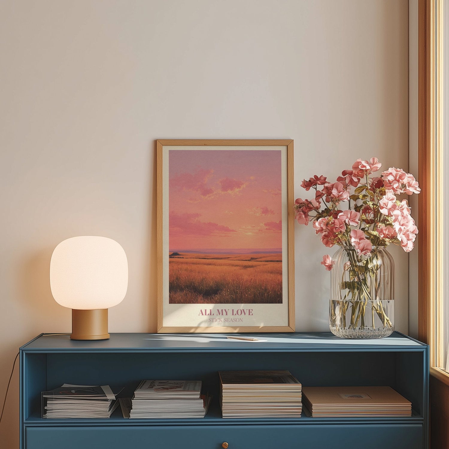 All My Love lyric wall art print inspired by Noah Kahan on a blue sideboard with a lamp and flowers