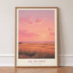 All My Love Noah Kahan print of a golden field under a glowing pink sunset, in an oak frame, leaning against a wall on a herringbone floor