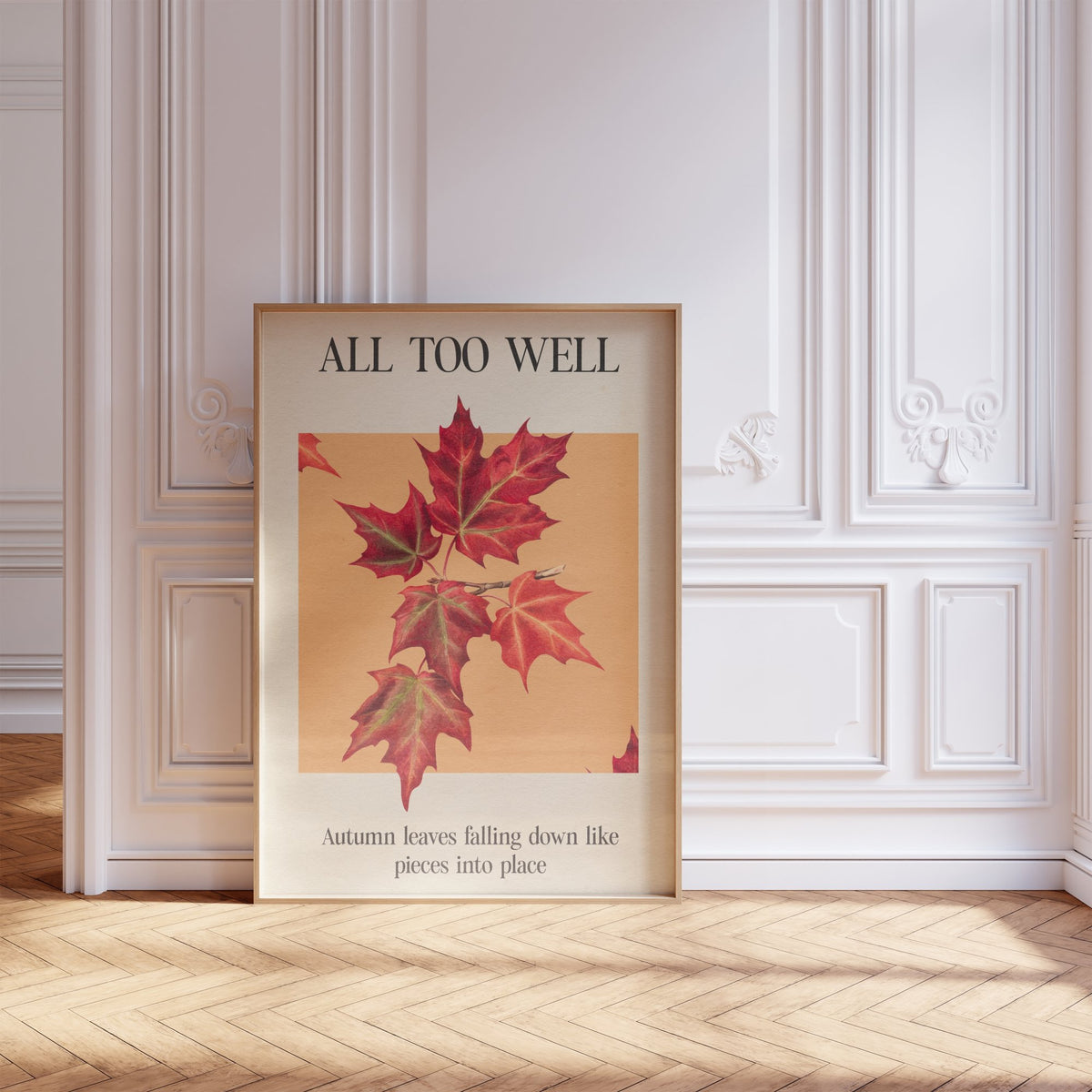 All Too Well Leaf Taylor Swift print of red maple leaves on a peach square, framed, leaning against a white panelled wall