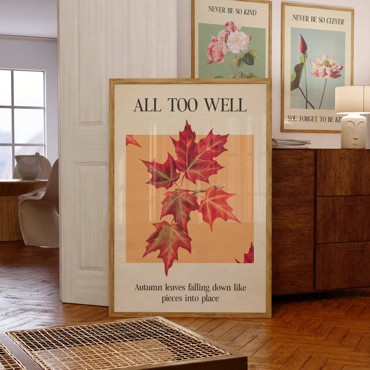 All Too Well Leaf Taylor Swift print of red maple leaves on a peach square, framed, leaning against a chest of drawers