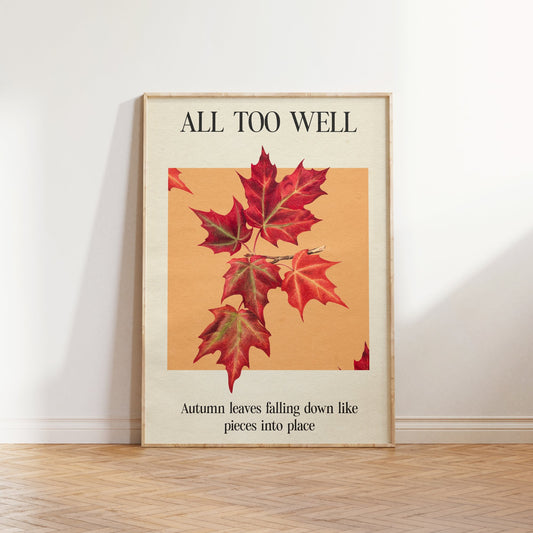 All Too Well Leaf Taylor Swift print of red maple leaves on a peach square, framed, leaning against a white wall