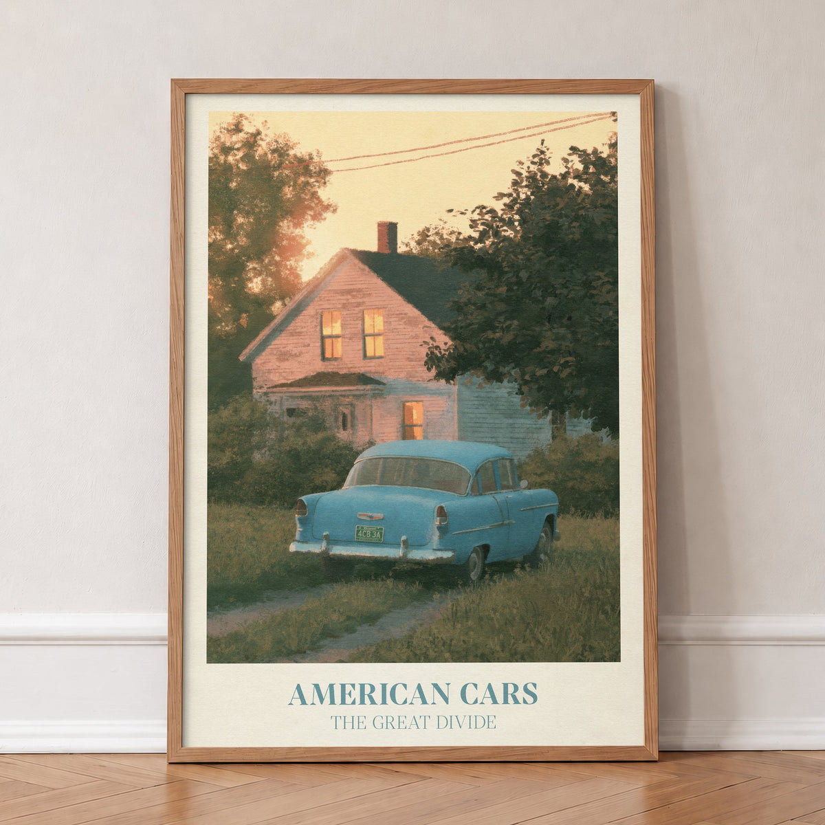 American Cars Noah Kahan print of a vintage blue car outside a glowing house at dusk, in an oak frame, leaning against a wall on a herringbone floor