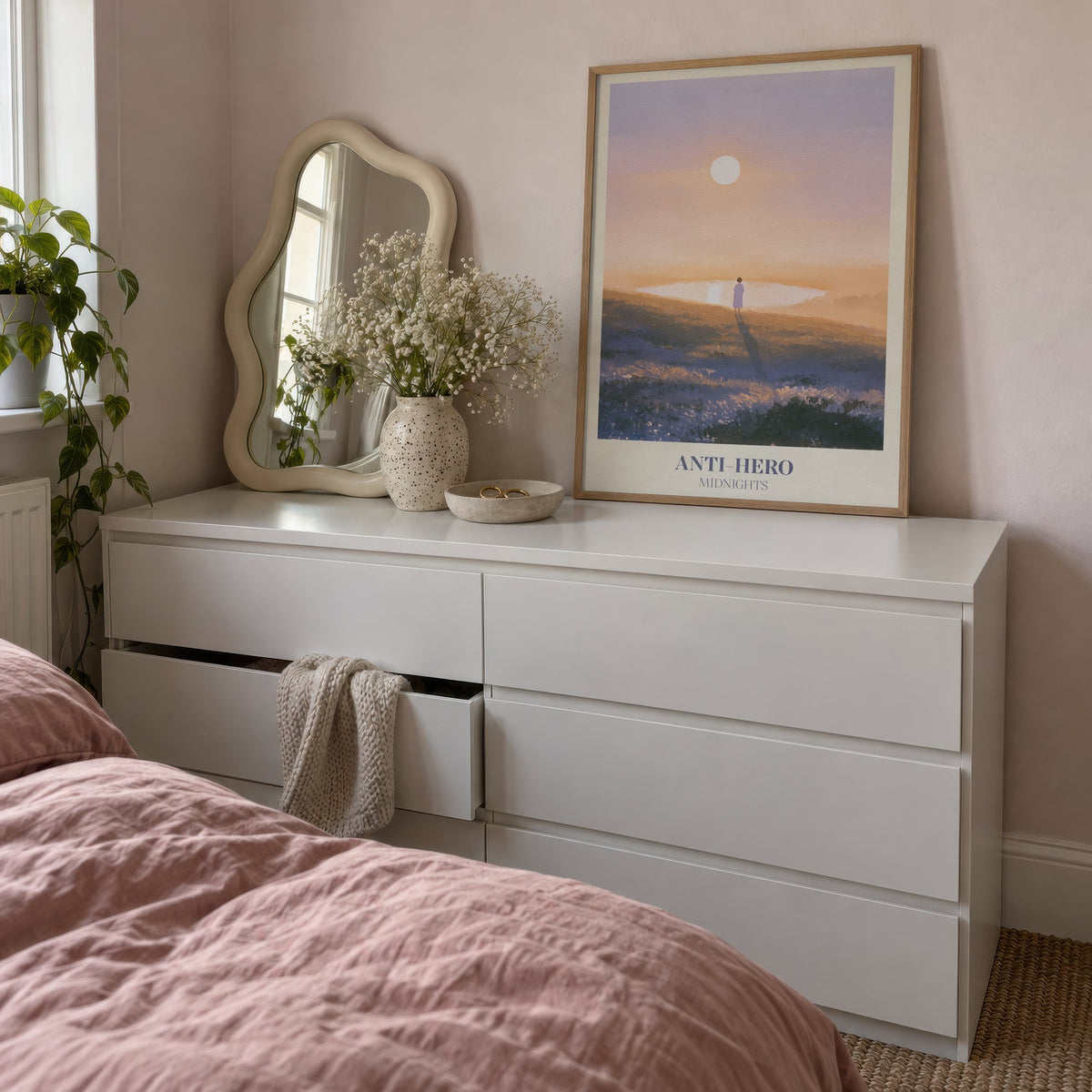 Anti-Hero Taylor Swift print of a lone figure by a lake at sunset, leaning on a white dresser beside a wavy mirror