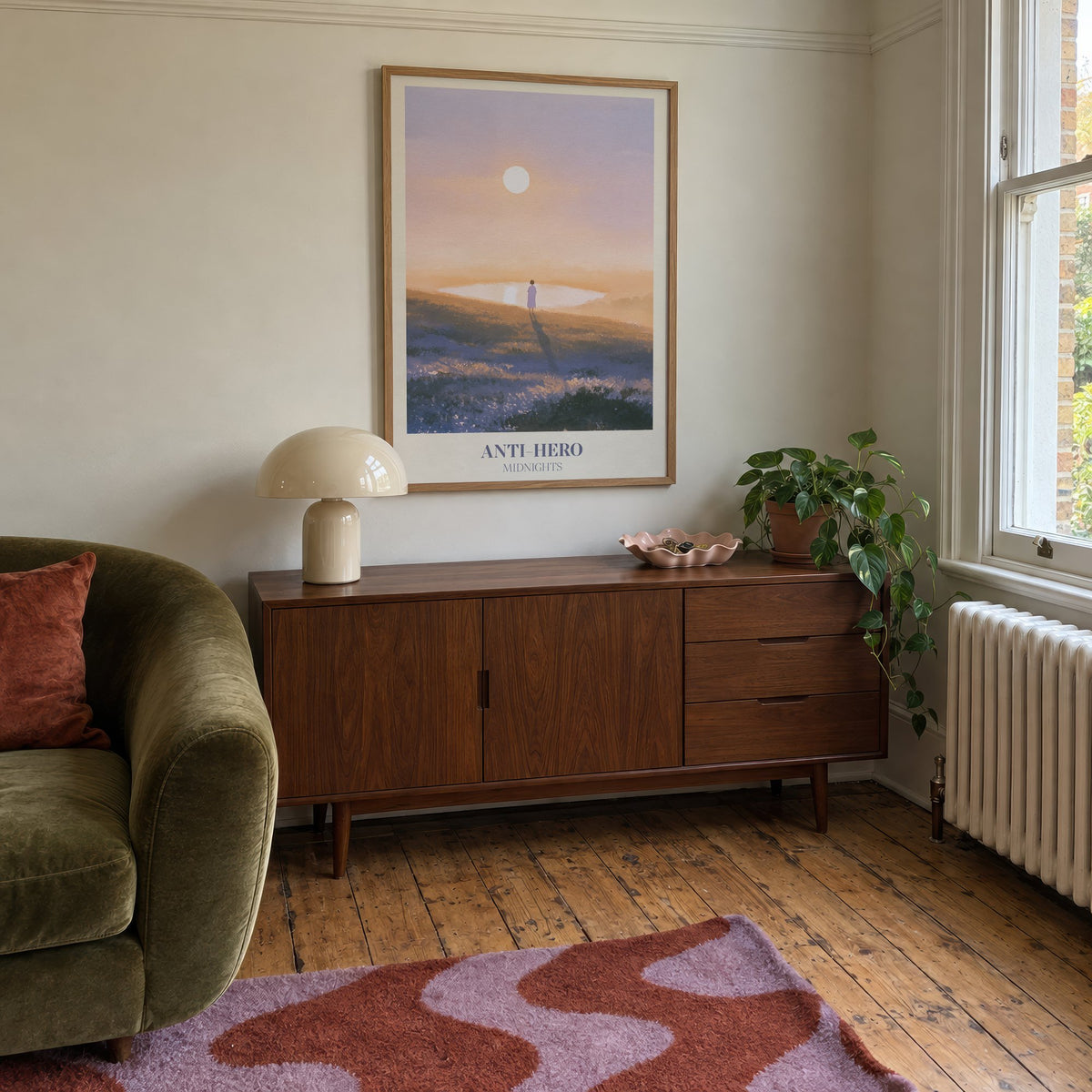 Anti-Hero Taylor Swift print of a lone figure by a lake at sunset, hung above a mid-century sideboard