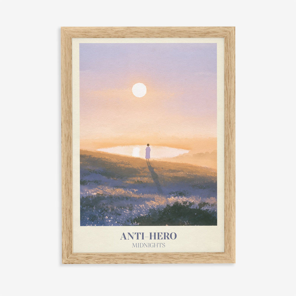 Anti-Hero Taylor Swift print of a lone figure by a lake at sunset, in an oak frame on a plain wall