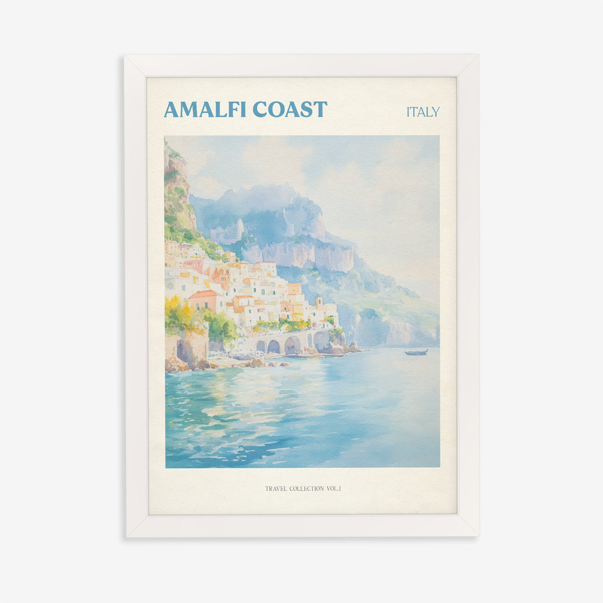 Amalfi Coast travel print of pastel houses on the cliffs above a turquoise sea, in a white frame on a plain wall