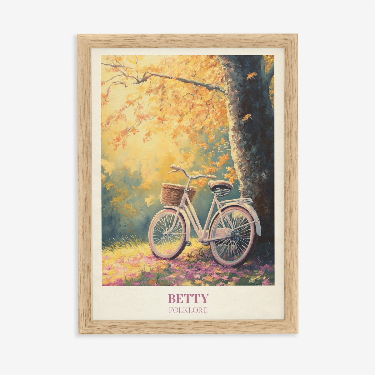 Betty Taylor Swift print of a white bicycle with a basket under an autumn tree, in an oak frame on a plain wall