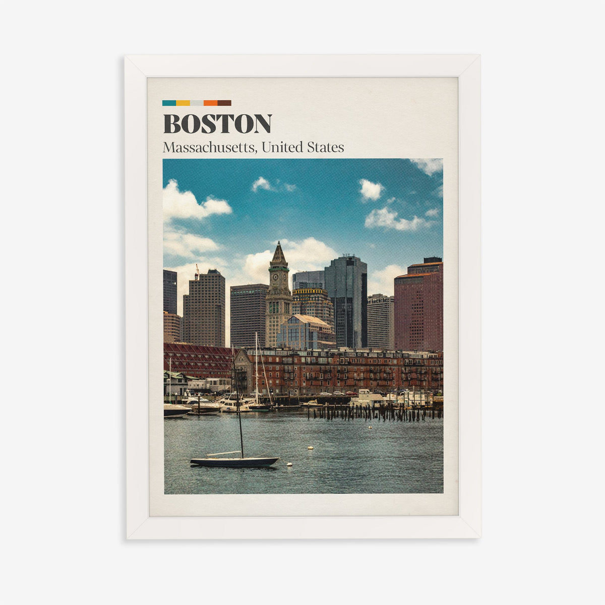 Boston travel print of the harbour skyline and Custom House clock tower behind a small sailboat, in a white frame on a plain wall