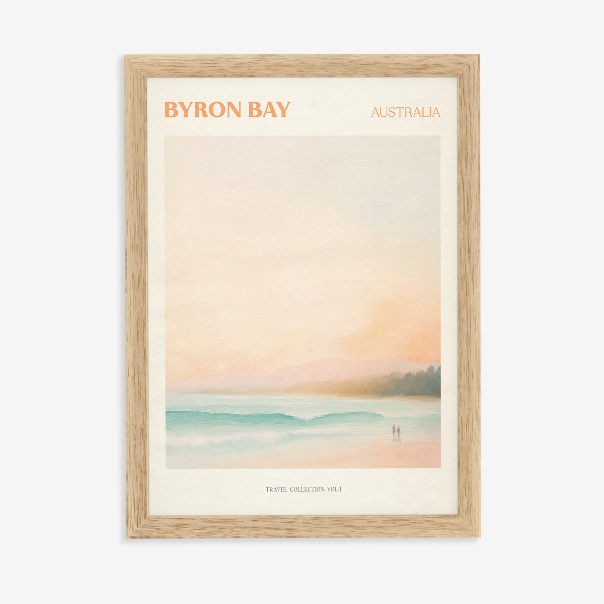 Byron Bay travel print of a pastel beach at first light with two people on the sand, in an oak frame on a plain wall