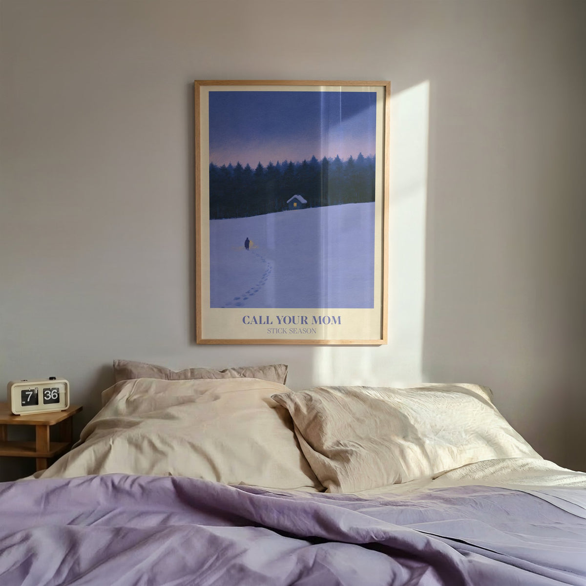 Call Your Mom Winter Noah Kahan print of a lone walker heading to a lit cabin in the snow, hung above a bed with lilac bedding