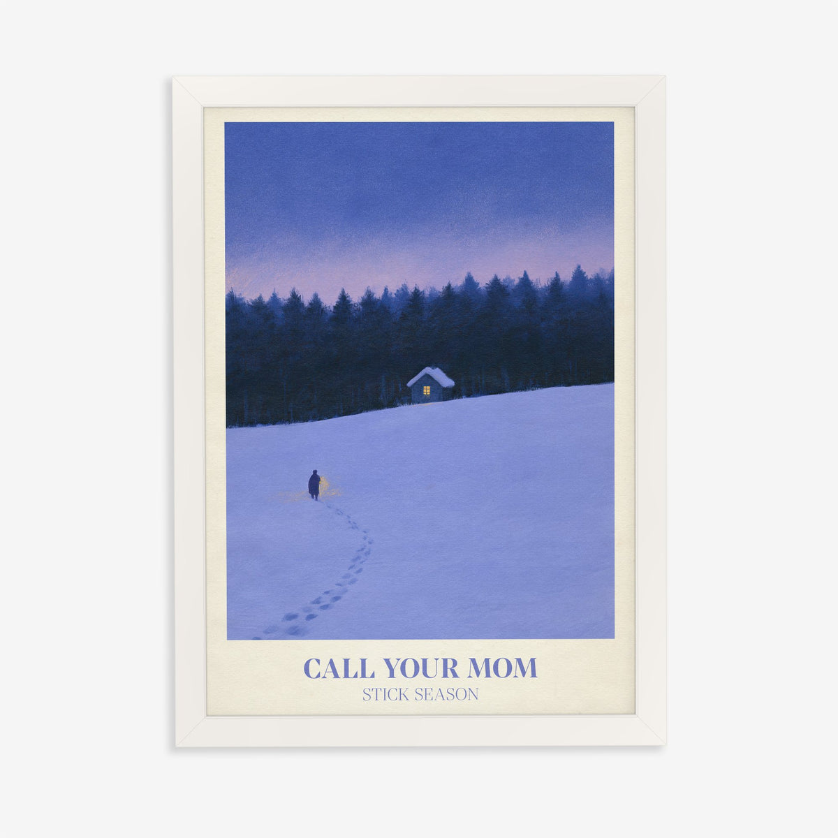 Call Your Mom Winter Noah Kahan print of a lone walker heading to a lit cabin in the snow, in a white frame on a plain wall