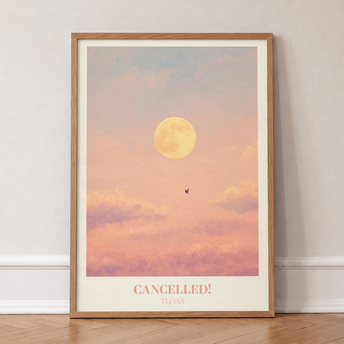 Cancelled Taylor Swift print of a full moon and a lone bird in a peach sky, in an oak frame, leaning against a wall on a herringbone floor