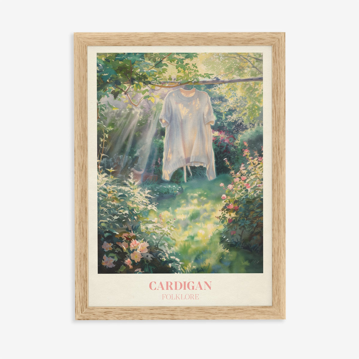Cardigan Taylor Swift print of a cream cardigan hanging from a branch in a rose garden, in an oak frame on a plain wall