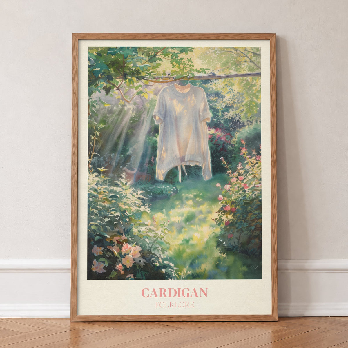 Cardigan Taylor Swift print of a cream cardigan hanging from a branch in a rose garden, in an oak frame, leaning against a wall on a herringbone floor