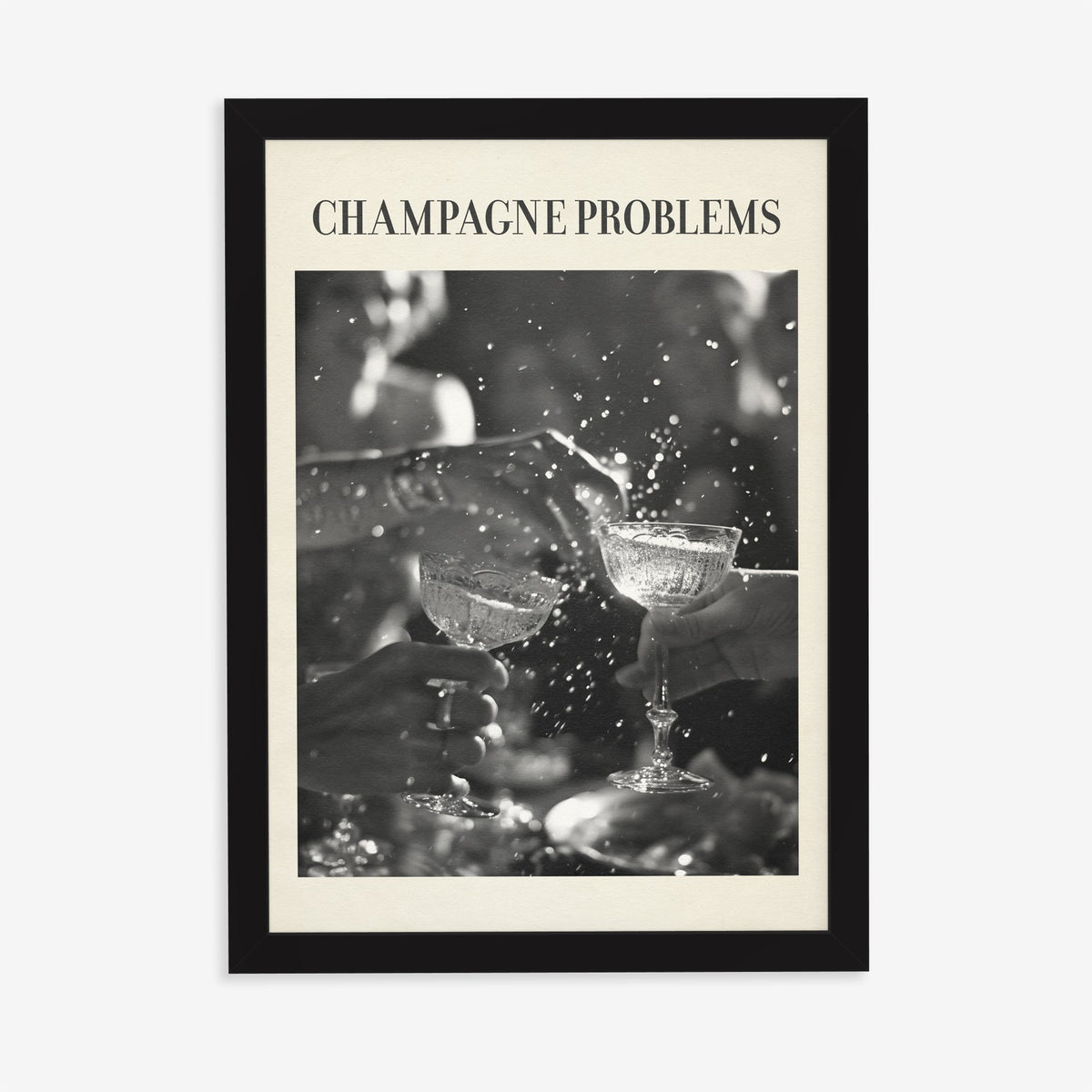Champagne Problems Retro Taylor Swift print of two champagne coupes clinking in black and white, in a black frame on a plain wall