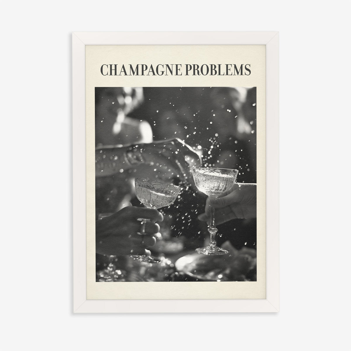 Champagne Problems Retro Taylor Swift print of two champagne coupes clinking in black and white, in a white frame on a plain wall