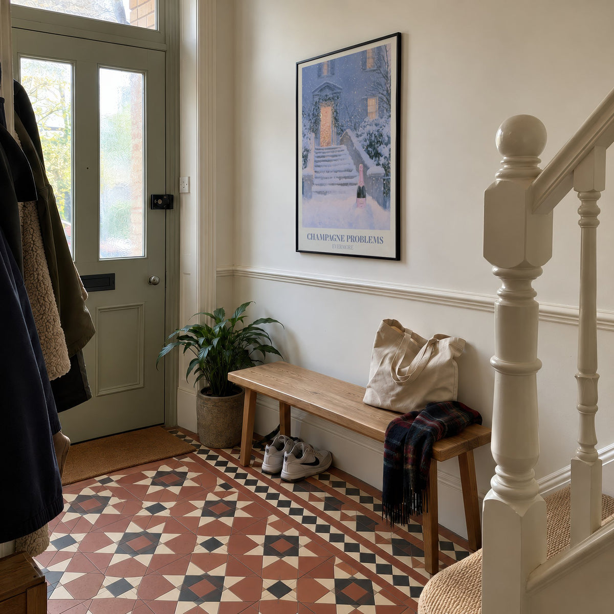 Champagne Problems Winter Taylor Swift print of champagne on snowy steps, hung in a hallway with Victorian floor tiles