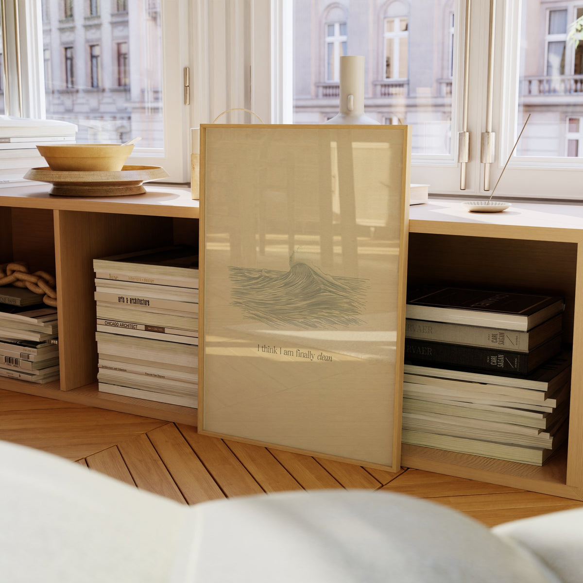 Clean Minimal Taylor Swift print of a line-drawn breaking wave on cream paper, framed on a bookcase by a window