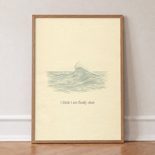 Clean Minimal Taylor Swift print of a line-drawn breaking wave on cream paper, in an oak frame, leaning against a wall on a herringbone floor