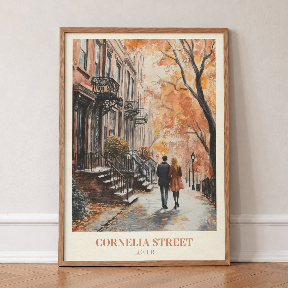 Cornelia Street Taylor Swift print of a couple walking an autumn street of brick townhouses, in an oak frame, leaning against a wall on a herringbone floor