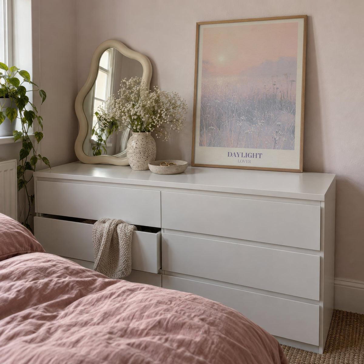 Daylight Winter Taylor Swift print of a frosty meadow at sunrise, leaning on a white dresser beside a wavy mirror