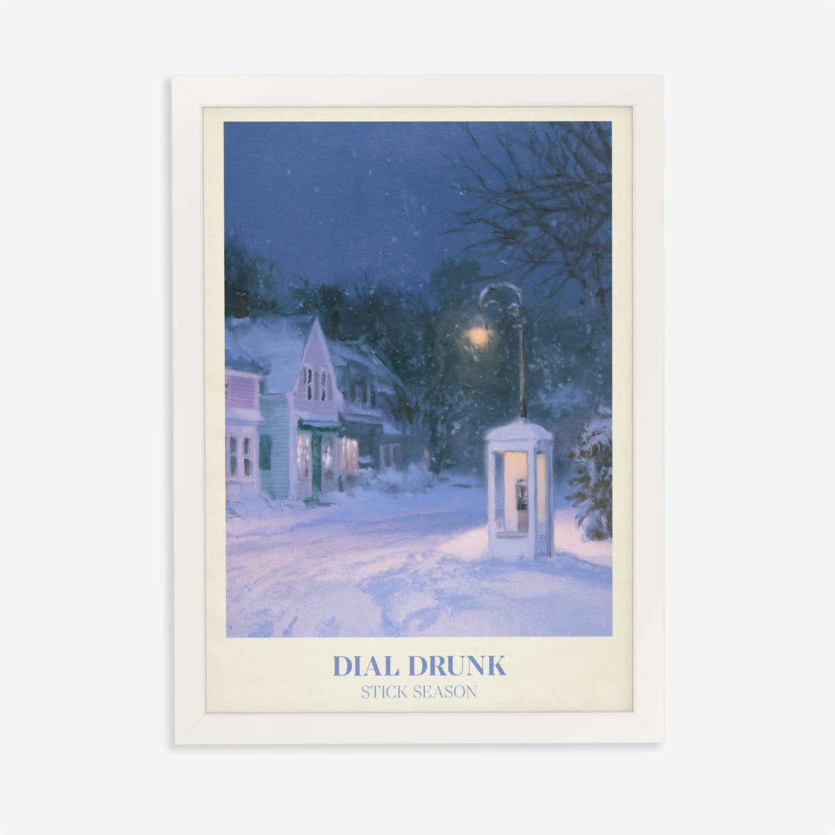Dial Drunk Noah Kahan print of a phone box on a snowy village street at night, in a white frame on a plain wall