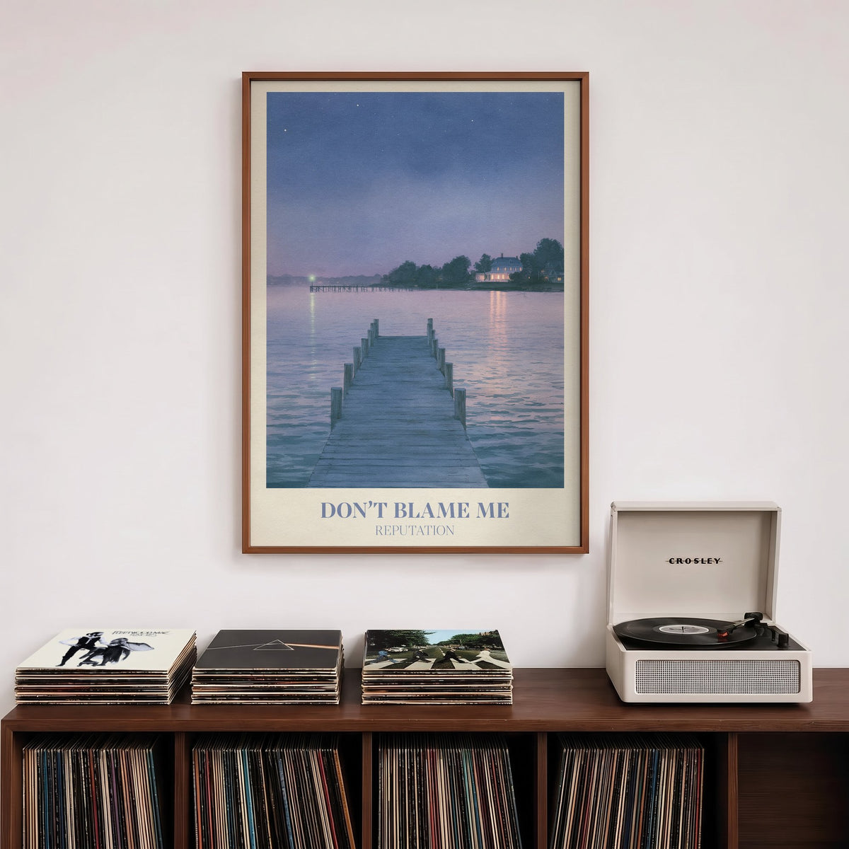 Don’t Blame Me Taylor Swift print of a jetty on a lake at dusk, hung above a record shelf and a record player