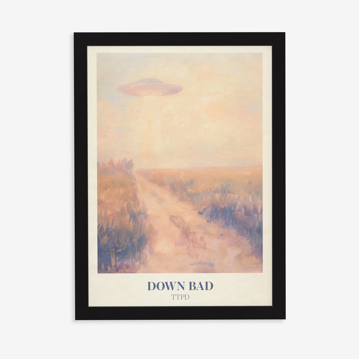Down Bad Taylor Swift print of a UFO beaming light over a dusty track through golden fields, in a black frame on a plain wall