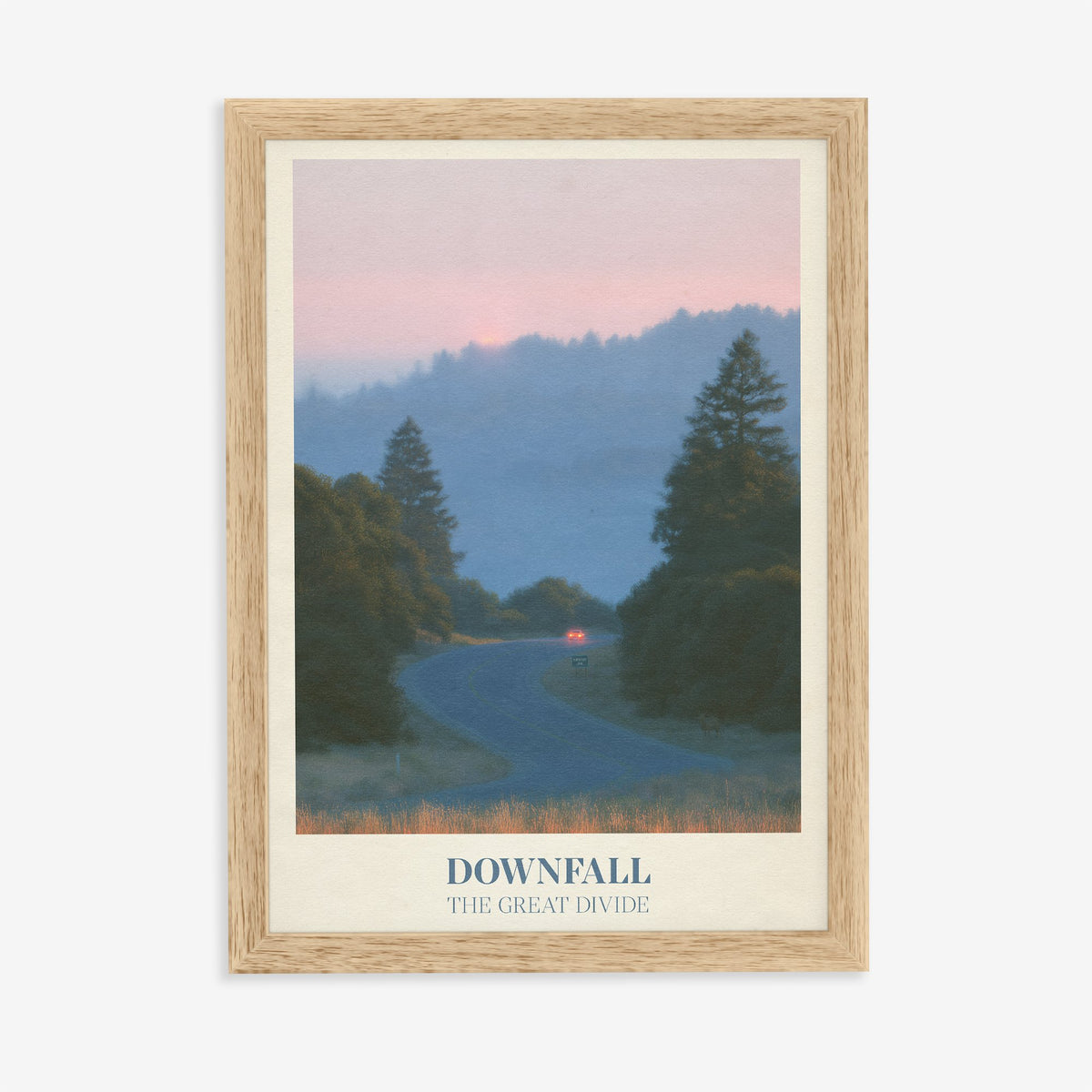 Downfall Noah Kahan print of a winding road through misty pine hills at dusk, in an oak frame on a plain wall