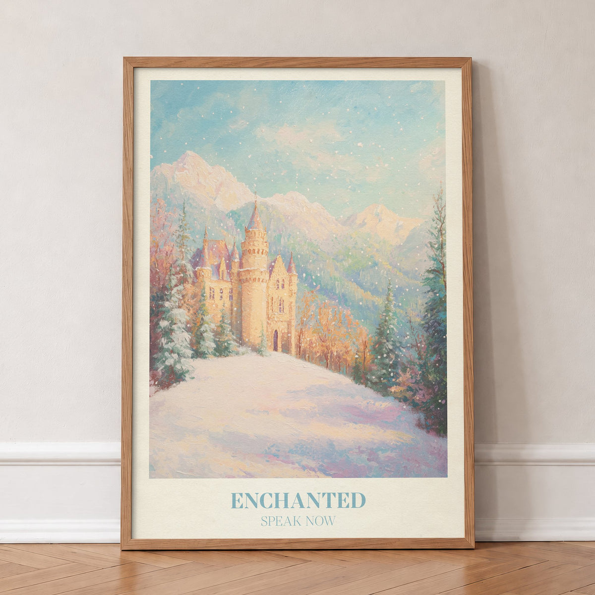 Enchanted Christmas Taylor Swift print of a castle on a snowy hill below the mountains, in an oak frame, leaning against a wall on a herringbone floor