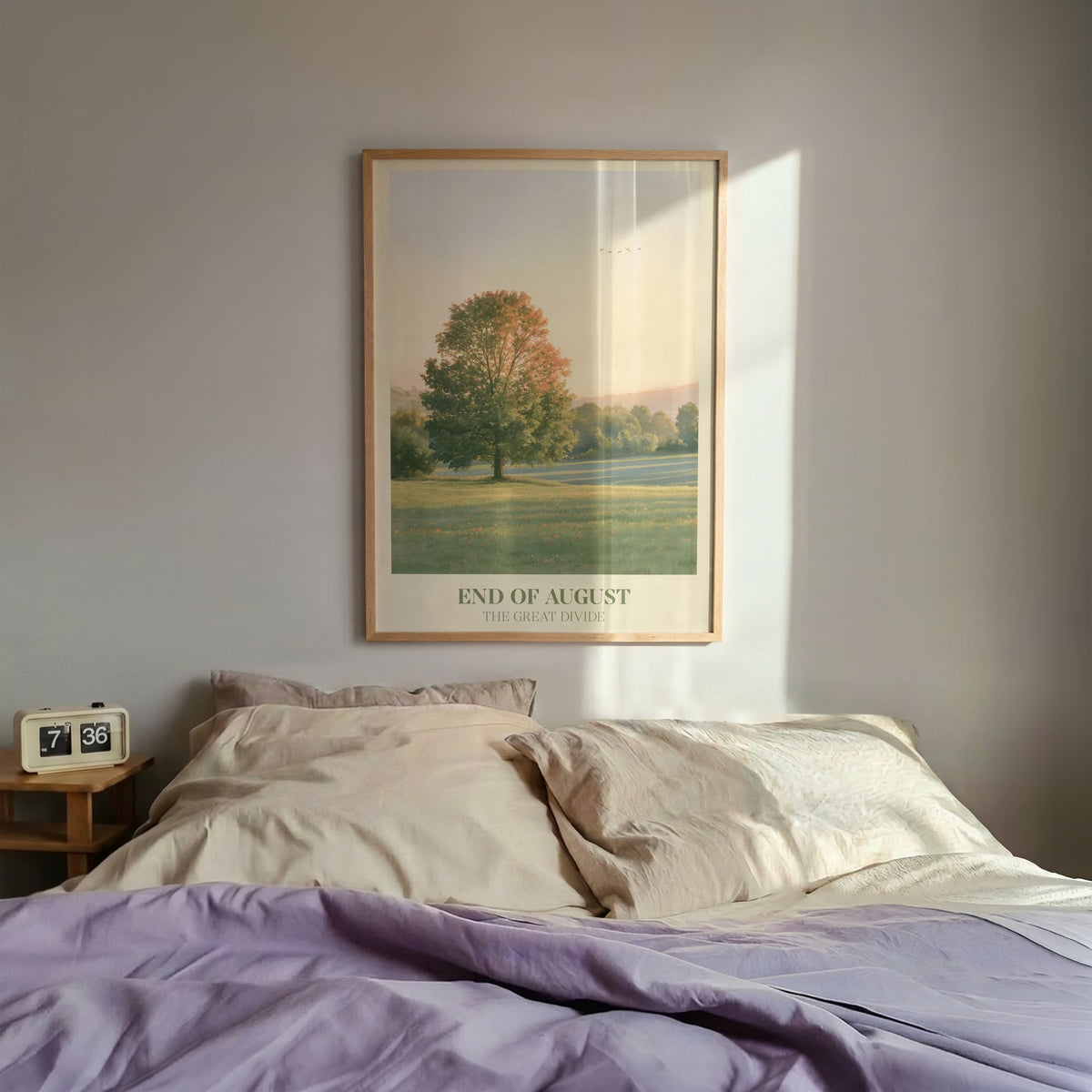 End of August Noah Kahan print of a lone tree in a late-summer field, framed above a bed with lilac bedding