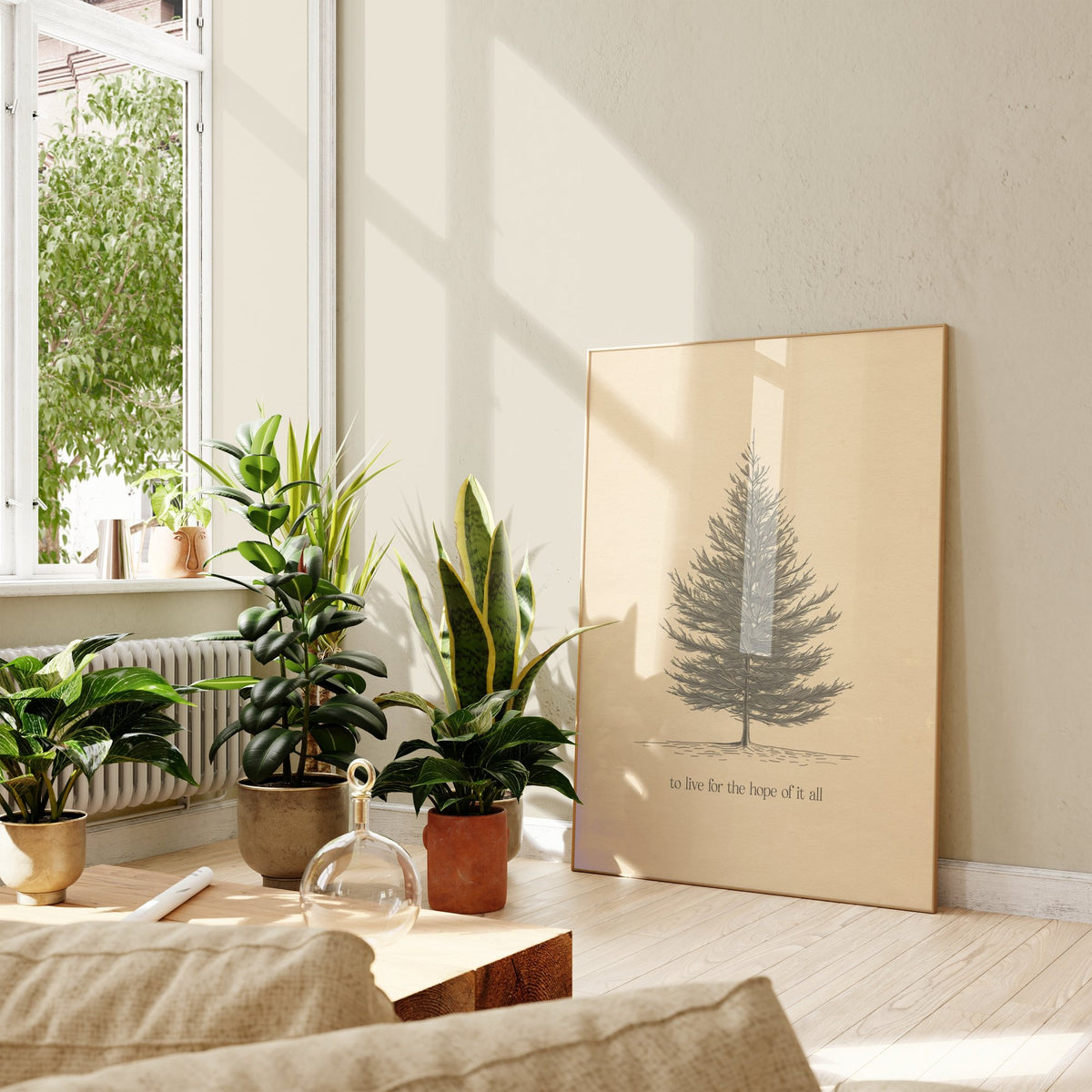 For The Hope Of It All Minimal Taylor Swift print of a pencil-drawn pine tree on cream, framed, leaning against a wall beside potted plants