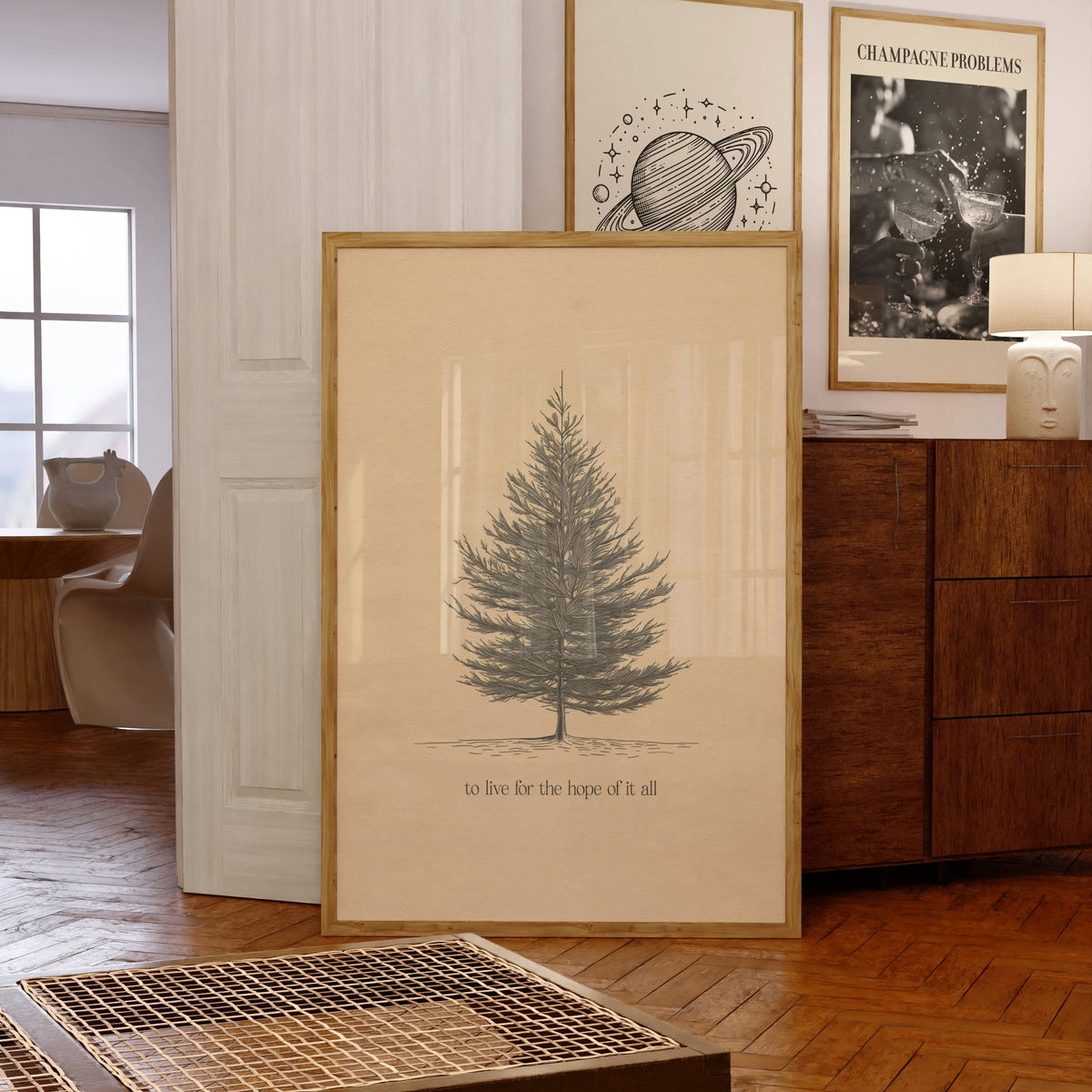 For The Hope Of It All Minimal Taylor Swift print of a pencil-drawn pine tree on cream, framed, leaning against a chest of drawers