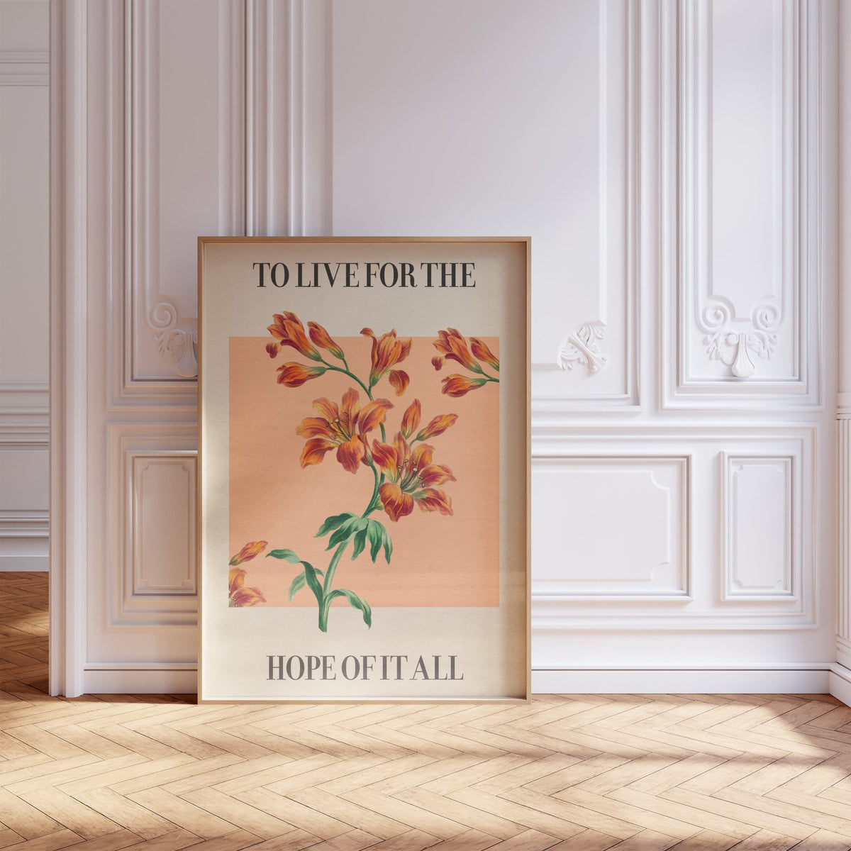 For The Hope Of It All Taylor Swift print of orange lilies on a peach square, framed, leaning against a white panelled wall